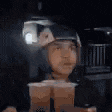 a man wearing a hat and glasses is screaming in a blurry photo .