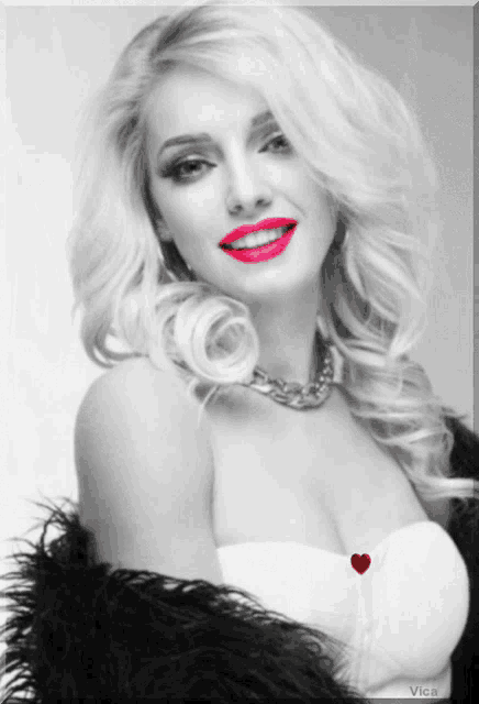 a black and white photo of a woman with a heart on her chest