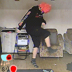 a person with pink hair is dancing in a room