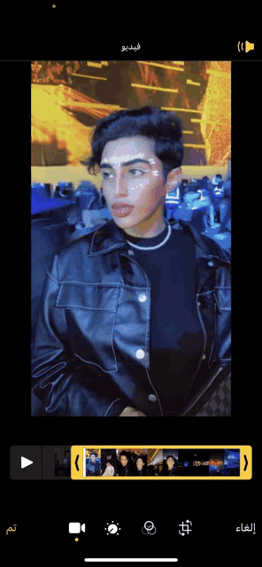 a man in a leather jacket is being edited on a cell phone