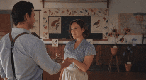 a man and a woman are dancing in front of a chalkboard that says honey