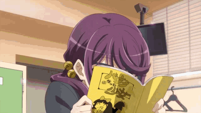 a girl with purple hair is reading a book with chinese writing on it