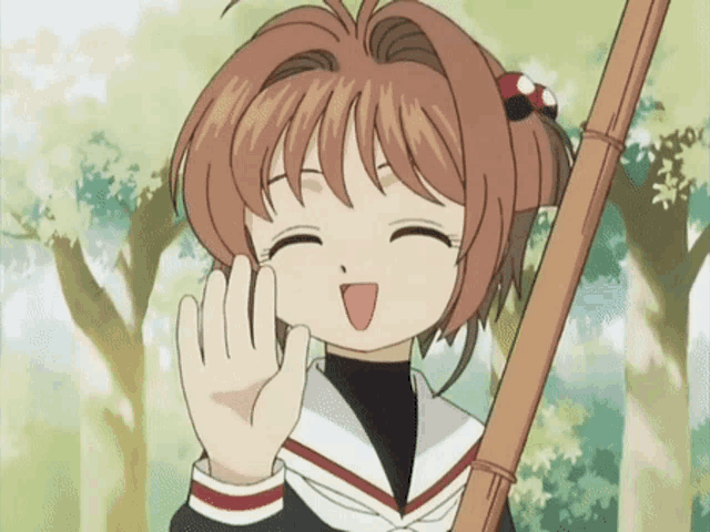 a girl in a school uniform is smiling and holding a stick