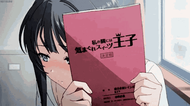 a girl is holding a pink book that says ' princess ' on it