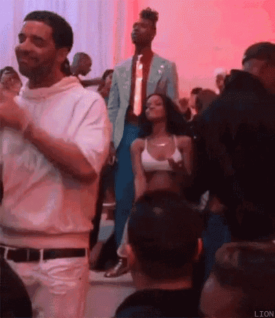 a man and a woman are dancing in a crowd of people .