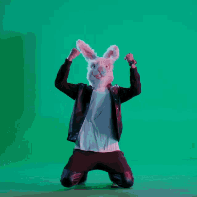 a man wearing a bunny mask kneeling on the floor