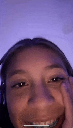 a close up of a girl 's face with braces on it .