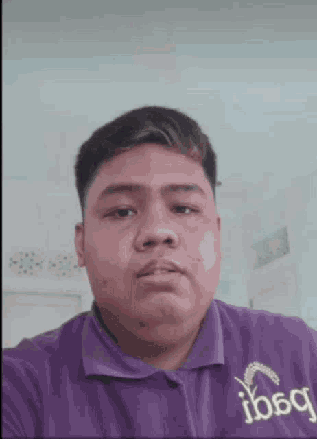 a man wearing a purple shirt that says ibbq