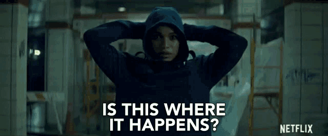 a woman in a hooded jacket is standing in a building and asking is this where it happens ? netflix .
