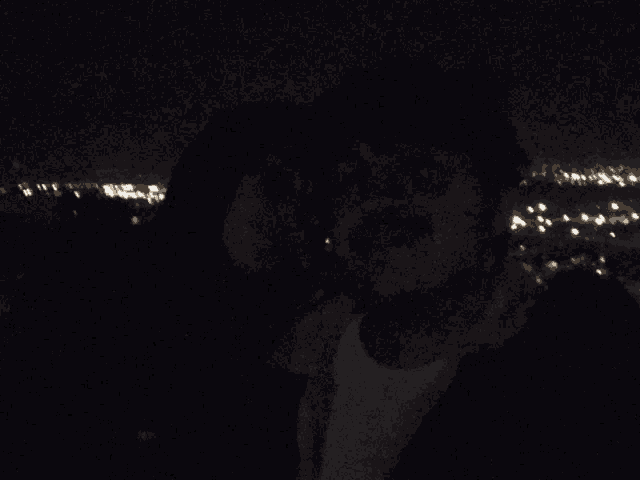 a man and a woman kissing in the dark