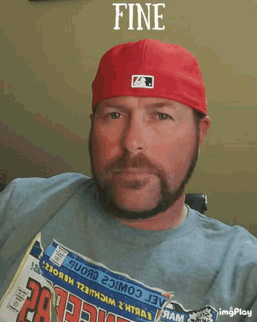 a man with a beard wearing a red hat and a blue shirt with the word fine on it