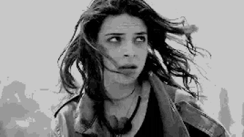 a black and white photo of a woman with long hair and headphones .