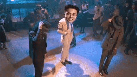 a man in a suit and tie is dancing with another man