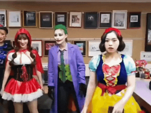 a group of people dressed in costumes including the joker