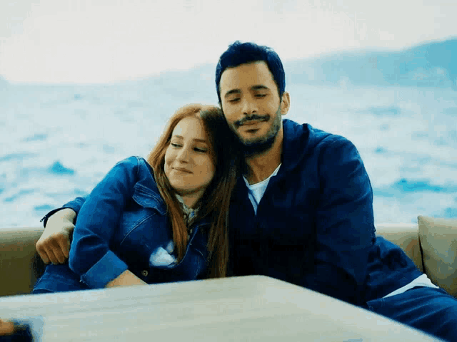 a man and a woman are sitting next to each other