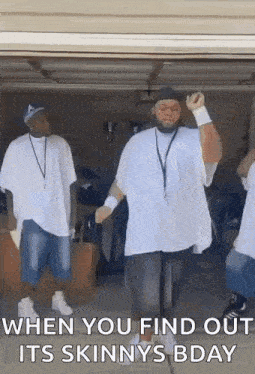 a man in a white shirt is dancing in a garage .