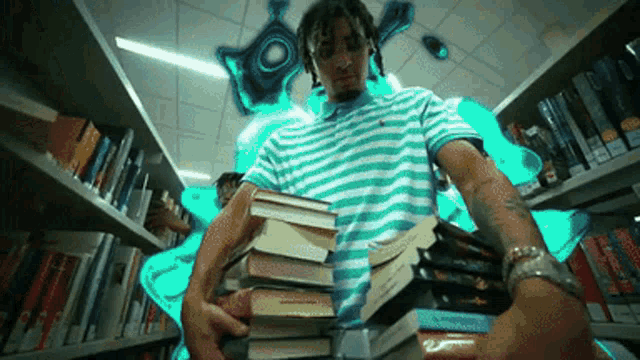 a man in a blue and white striped shirt holds a stack of books