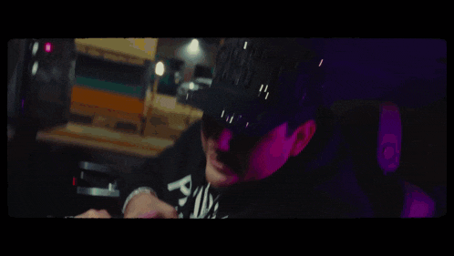 a man smoking a cigarette in a car with purple lights