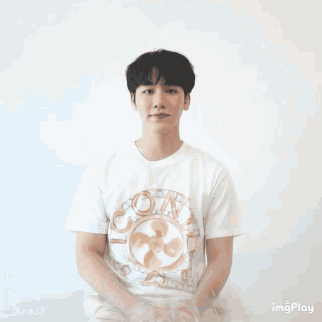 a young man wearing a white t-shirt with the word icon on it