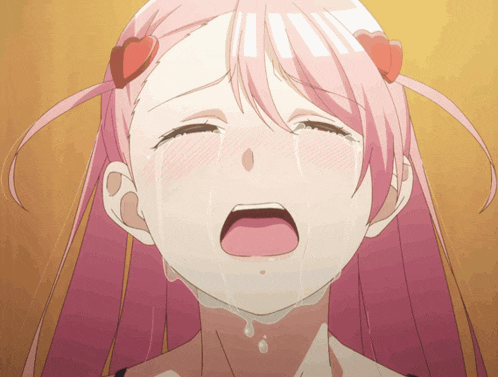 a girl with pink hair is crying with tears running down her face