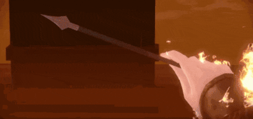 a person is holding a sword in their hand that is on fire .