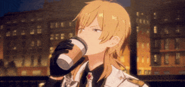 a man with long blonde hair drinks from a cup