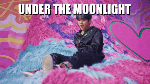 a man is sitting on a bed with the words under the moonlight