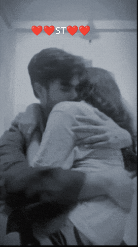 a black and white photo of a man and a woman hugging with the word st above them