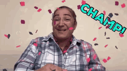 a woman in a plaid shirt is smiling with confetti falling around her and the word champ written on the bottom