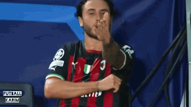 a man wearing a red and black jersey with the number 3 on the front