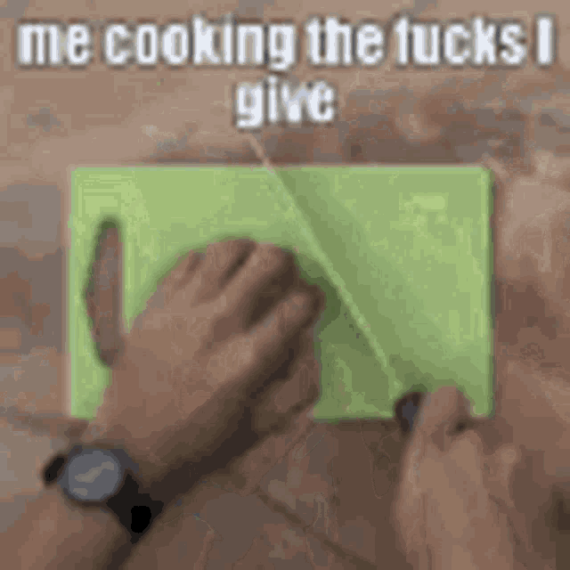 a person is cutting a piece of meat on a cutting board .