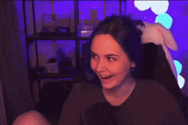 a girl sitting in a secret lab chair laughing
