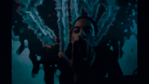 a man with a ring on his finger is covering his face with his hands