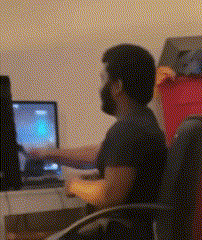 a man with a beard is sitting in front of a computer