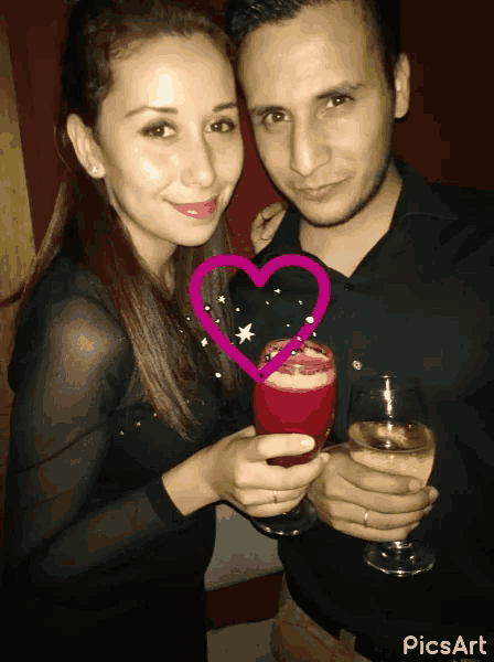 a man and a woman are holding wine glasses with a heart in the middle