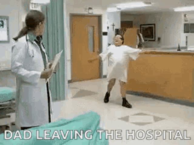 a doctor is standing next to a patient in a hospital gown .