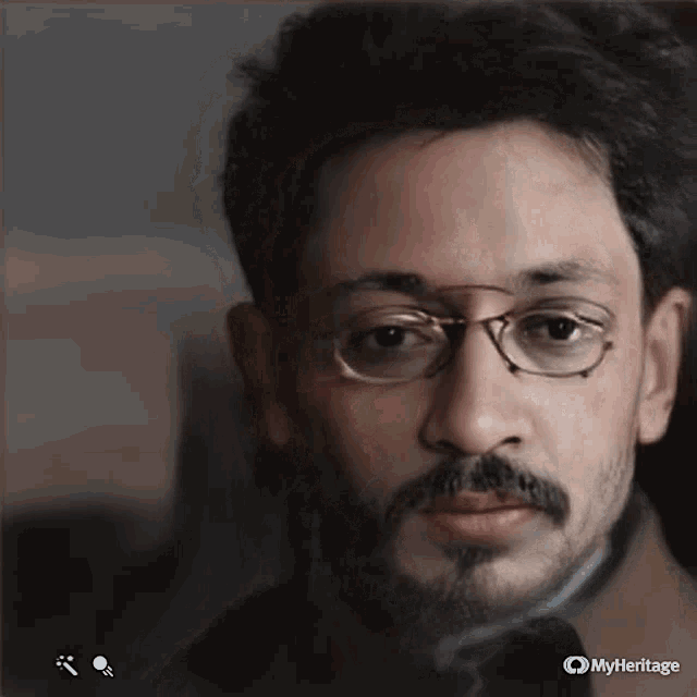a close up of a man 's face with glasses and a beard taken by myheritage