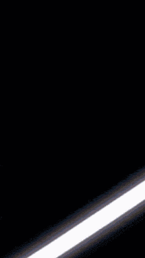 a light beam is coming out of a dark background