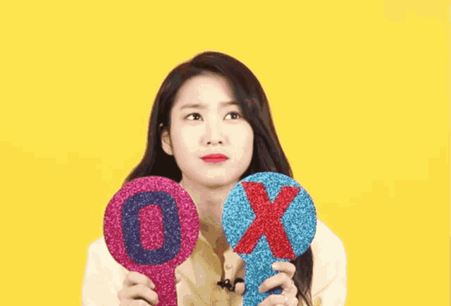 a woman is holding two signs in front of her face that say ox .