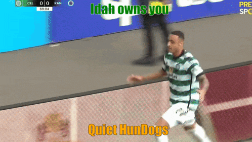 a soccer player is running on the field with the words " idah owns you quiet hundogs " on the bottom