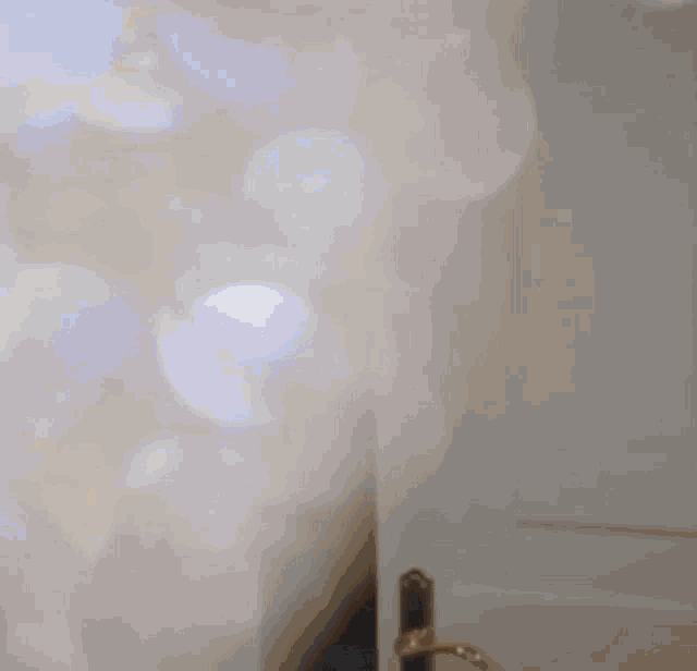 a blurry picture of a person standing in a doorway with a light shining through it .