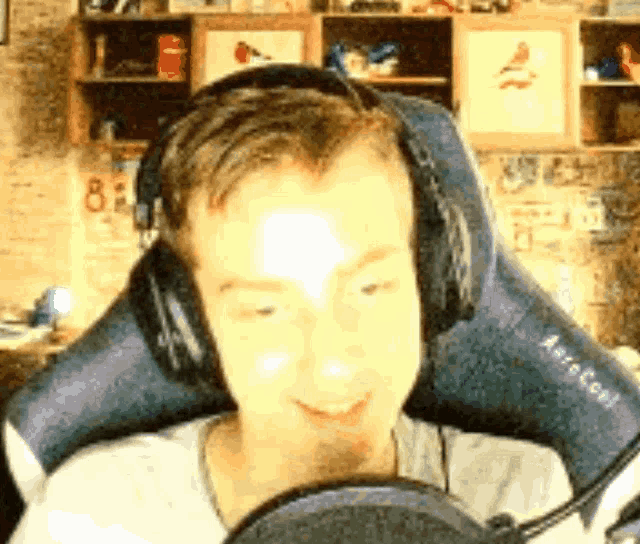 a man wearing headphones is sitting in a chair with the number 8 on it