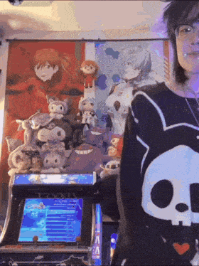 a person wearing a black shirt with a skull on it standing in front of an arcade machine