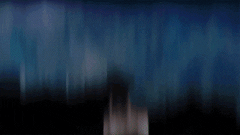 a silhouette of a person is standing in front of a blue background