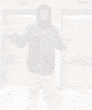 a man in a hoodie is standing in front of an elevator .