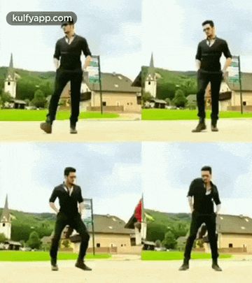 a man is dancing in a park in front of a house .