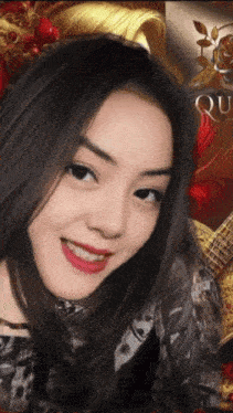 a close up of a woman 's face with the word queen on the bottom right