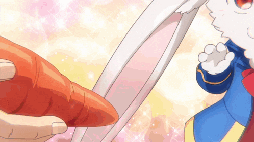 a person holding a carrot in front of a rabbit