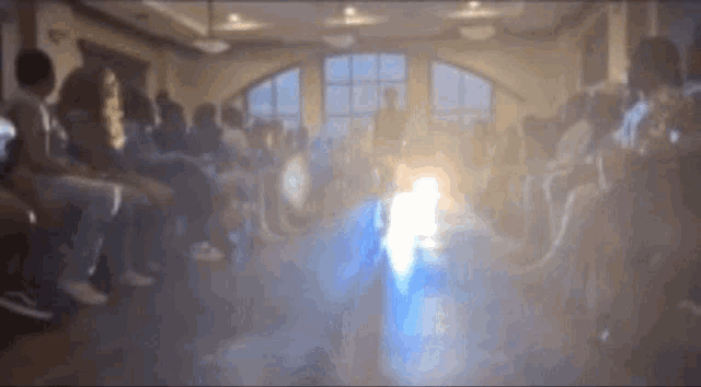 a blurry picture of a group of people sitting in a circle