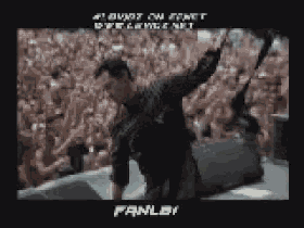 a man is standing on a stage with his arms outstretched in front of a crowd and the word fanley is on the bottom